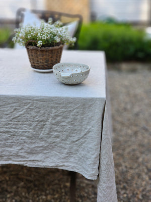 Relaxed farmhouse elegance is made easy with this Oatmeal Linen Tablecloth.  The earthy flax color creates an instant vintage feel inspired by old European farmhouse style. Washed linen is know for its softness and texture. This natural linen will quickly become a treasured heirloom. 100% Linen.