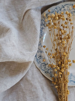 Relaxed farmhouse elegance is made easy with this Oatmeal Linen Tablecloth. The earthy flax color creates an instant vintage feel inspired by old European farmhouse style. Washed linen is know for its softness and texture. This natural linen will quickly become a treasured heirloom. 100% Linen. Made in the USA