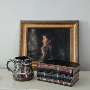 For a timeless look, this Old Book Stack reproduction is the perfect addition to any shelf. Crafted of resin, it features an authentic faux leather binding with distressed well-worn pages. The stack can rest upright or lie flat, adding an air of vintage charm to any space. 6.5" x 4.5" x 3"