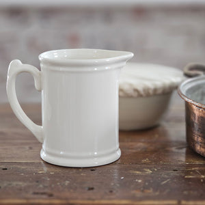 The Old Tavern Stoneware Pitcher combines a historic feel with a timeless design that effortlessly complements any home decor. Made of robust construction, it is perfect for everyday use and will elevate your serving game, whether for water, iced tea, or any other beverage. Antique white adds a touch of elegance. 5.25" Diam x 6.50"H (7.5"W with handle)