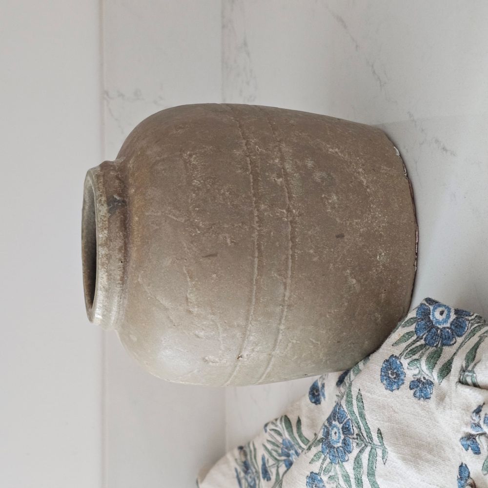 This handsome reproduction Old Style Crock Vase is inspired by early 20th century pottery found in farmhouses throughout the US and Europe. This sturdy, rustic crock has an aged patina, making this piece a perfect accent for those who love the perfectly imperfect look of vintage style home decor. Use to store cooking utensils or display your favorite flowers. 