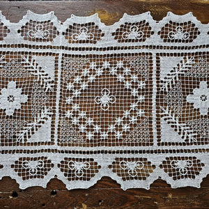 Our Old Tuscany Lace Table Runner adds old-world charm to any room. This sheer lace white runner has a dreamy vintage quality that is perfect for creating an country farmhouse look or for those who love cottage style. Features translucent white lace embroidered with a floral design and scalloped edging. 100% mercerized Cotton thread. 16”W x 45”L

Create easy no-sew cafe lace curtains with our curtain ring clips. Simply add two runners with one set of clips to create an old-world look.