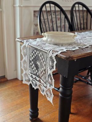 Our Old Tuscany Lace Table Runner adds old-world charm to any room. This sheer lace white runner has a dreamy vintage quality that is perfect for creating an country farmhouse look or for those who love cottage style. Features translucent white lace embroidered with a floral design and scalloped edging. 100% mercerized Cotton thread. 16”W x 45”L

Create easy no-sew cafe lace curtains with our curtain ring clips. Simply add two runners with one set of clips to create an old-world look.