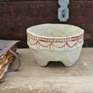 Handcrafted in the time-honored fashion and painted using a traditional henna technique, each Paper Mache Kashmir Bowl bring a unique character. Offered in four different patterns, each piece is one of a kind and are a beautiful accent for a bookshelf or a casual catchall. For decorative use only. Each bowl sold separately. 5.75" Diam x 3.75"H