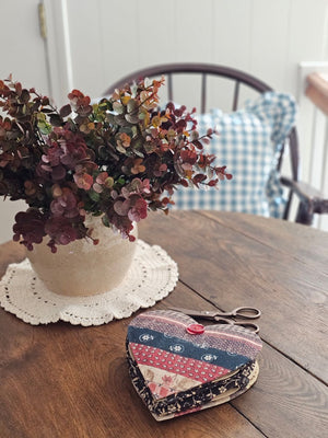 Our Patchwork Heart Sewing Kit has most everything you need for quick fixes and small projects. Perfect for travel or for the new homeowner or college student. It features a cushioned heart that folds out to reveal four sides filled with sewing notions, including 1 tape measure, 1 folding scissors, 3 thread colors, 3 safety pins, 3 sewing needles, 4 mother of pearl buttons, 1 seam ripper, and 1 needle threader. 6"L x 5"W x 2"H