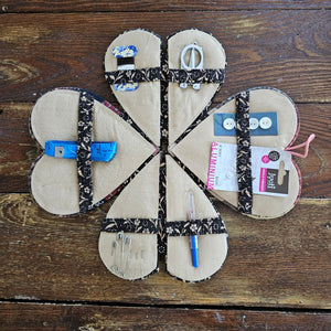 Our Patchwork Heart Sewing Kit has most everything you need for quick fixes and small projects. Perfect for travel or for the new homeowner or college student. It features a cushioned heart that folds out to reveal four sides filled with sewing notions, including 1 tape measure, 1 folding scissors, 3 thread colors, 3 safety pins, 3 sewing needles, 4 mother of pearl buttons, 1 seam ripper, and 1 needle threader. 6"L x 5"W x 2"H