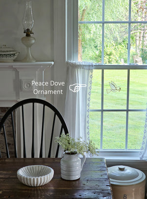 The Peace Dove Ornament, crafted from delicate capiz shell and accented with refined gold plating, adds an enchanted feel to any space. Its translucent glow brings a subtle, captivating charm, making it a graceful addition that enhances any space with a touch of serene elegance. Approximately 4.5"L x 3.5"H