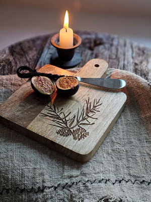 Enhance your home decor with our Simple Distressed Taper Candle Holder. Featuring a primitive and minimalist design, this black metal holder boasts a distressed finish that adds hints of grey and rust, creating a rustic ambiance. Perfect for adding a quiet simplicity to any room. Taper candle not included. 2"Diam x 1.5"H