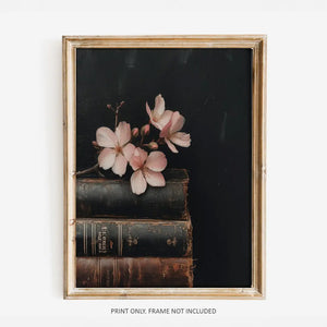 This Vintage Still Life Art Print with Pink Blossoms and Books adds an enchanting charm to any room. Pinks, browns, blacks blend together to create this moody still-life. The art is printed on high quality card stock with archival ink. Original art has been digitally retouched to preserve characteristics, grain and cracks. Image size: 8"x10". Print only. No frame included.