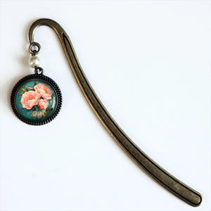 The Peony Book Hook makes a lovely gift for the book lover. Vintage romance is infused in this bookmark that features a glass cabochon and antique bronze hook with a pearl bead accent.