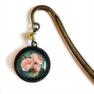 The Peony Book Hook makes a lovely gift for the book lover. Vintage romance is infused in this bookmark that features a glass cabochon and antique bronze hook with a pearl bead accent.