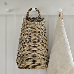 With a bit of old French country charm and simplicity, our Plymouth Willow Wall Basket is a farmhouse accent that has plenty of practicality. Store long serving utensils or let it overflow with your favorite dried flowers. No matter what you choose to stash away in this primitive style basket, it will look right at home in your farmhouse. (Dish Towel and flowers not Included.) 7”L x 13”H