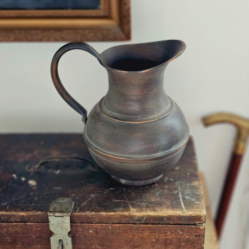 Introduce a touch of old-world elegance with the Pompei Pitcher. Crafted from metal with an aged copper look, this pitcher boasts a beautiful brown hue with hints of copper accenting its surface. Perfect for creating stunning floral arrangements, it makes a lovely addition to any decor. 