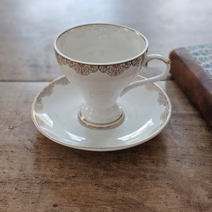 White Porcelain Tea Cup and Saucer with Gold Lace Design