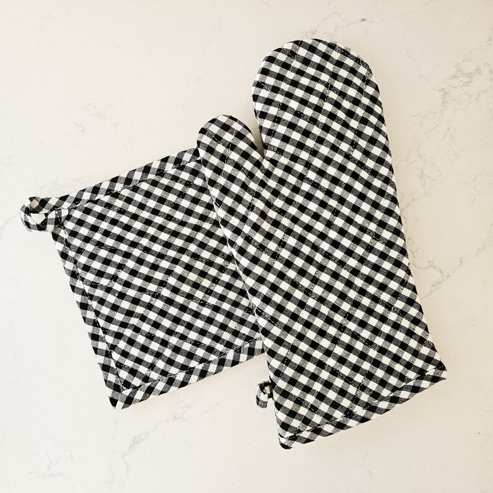 Our Potholder and Oven Mitt Set, Black and White Gingham offers classic farmhouse style. The gingham offer relaxed country charm and brightens any home. Perfect for everyday farmhouse living. Both feature a hoop for hanging. 100% Cotton. Machine wash. Includes one potholder and one mitt.