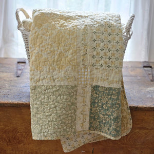 Add a cozy, vintage farmhouse feel to a guest room or reading nook with this quilted throw. Our Prairie Meadow Patchwork Quilt Throw Blanket is made of 100% cotton. Featuring a classic patchwork design in soothing shades of sage green, beige, white, buttercream gold, and cream, this throw adds a serene, cottage-inspired touch to any space. Crafted with a 100% soft cotton cover, it’s lightweight yet warm—perfect for year-round use.