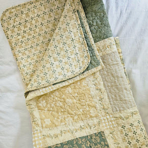 Add a cozy, vintage farmhouse feel to a guest room or reading nook with this quilted throw. Our Prairie Meadow Patchwork Quilt Throw Blanket is made of 100% cotton. Featuring a classic patchwork design in soothing shades of sage green, beige, white, buttercream gold, and cream, this throw adds a serene, cottage-inspired touch to any space. Crafted with a 100% soft cotton cover, it’s lightweight yet warm—perfect for year-round use.