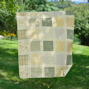 Add a cozy, vintage farmhouse feel to a guest room or reading nook with this quilted throw. Our Prairie Meadow Patchwork Quilt Throw Blanket is made of 100% cotton. Featuring a classic patchwork design in soothing shades of sage green, beige, white, buttercream gold, and cream, this throw adds a serene, cottage-inspired touch to any space. Crafted with a 100% soft cotton cover, it’s lightweight yet warm—perfect for year-round use.