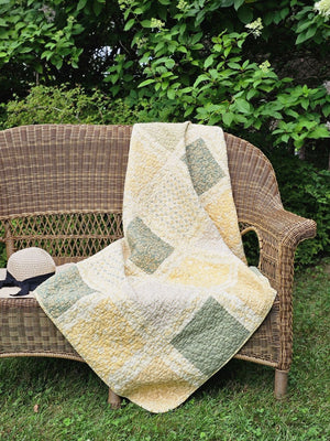 Add a cozy, vintage farmhouse feel to a guest room or reading nook with this quilted throw. Our Prairie Meadow Patchwork Quilt Throw Blanket is made of 100% cotton. Featuring a classic patchwork design in soothing shades of sage green, beige, white, buttercream gold, and cream, this throw adds a serene, cottage-inspired touch to any space. Crafted with a 100% soft cotton cover, it’s lightweight yet warm—perfect for year-round use.