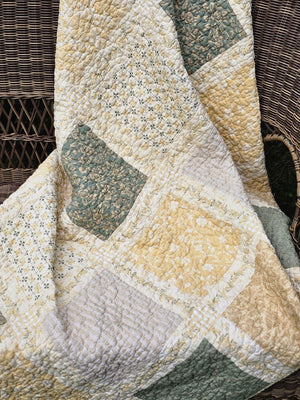 Add a cozy, vintage farmhouse feel to a guest room or reading nook with this quilted throw. Our Prairie Meadow Patchwork Quilt Throw Blanket is made of 100% cotton. Featuring a classic patchwork design in soothing shades of sage green, beige, white, buttercream gold, and cream, this throw adds a serene, cottage-inspired touch to any space. Crafted with a 100% soft cotton cover, it’s lightweight yet warm—perfect for year-round use.