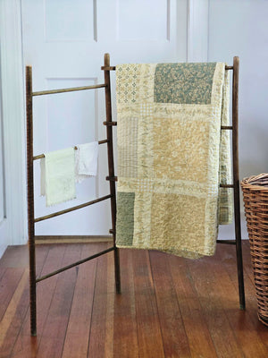 Add a cozy, vintage farmhouse feel to a guest room or reading nook with this quilted throw. Our Prairie Meadow Patchwork Quilt Throw Blanket is made of 100% cotton. Featuring a classic patchwork design in soothing shades of sage green, beige, white, buttercream gold, and cream, this throw adds a serene, cottage-inspired touch to any space. Crafted with a 100% soft cotton cover, it’s lightweight yet warm—perfect for year-round use.