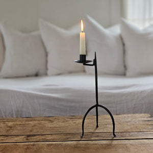 Crafted in the style of an antique reproduction, this candle holder pays homage to our Colonial heritage. Its timeless beauty suits both Early American homes and rustic farmhouses. The tripod style Primitive Wrought Iron Table Taper Candle Holder features an aged finish, protected by a durable lacquer coating to ensure resistance to scratches and rust, guaranteeing lasting appeal.