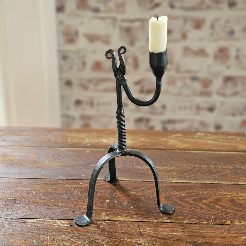 Crafted in the style of an antique reproduction, this candle holder pays homage to our Colonial heritage. Its timeless beauty suits both Early American homes and rustic farmhouses. The tripod style Primitive Wrought Iron Table Taper Candle Holder with a twist features an aged finish, protected by a durable lacquer coating to ensure resistance to scratches and rust, guaranteeing lasting appeal.