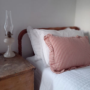 Add instant vintage charm to any room with our Red Ticking Stripe Accent Pillow. The ruffled edges lend a sweet cottage feel. County red and tan ticking stripes give this accent pillow timeless style. Includes two wood buttons on the back for easy removal. 100% Cotton. Machine Wash. Includes pillow insert.