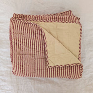 Whether you're creating a farmhouse style bedroom, a cozy cabin nook or a cottage guest room, our Red Ticking Stripe Quilt offers vintage charm. This hand-quilted, 100% cotton coverlet gets softer with each washing. Features popular ticking stripes in red along with a buttery oat stripe on one side and a solid buttery oat on the reverse side.