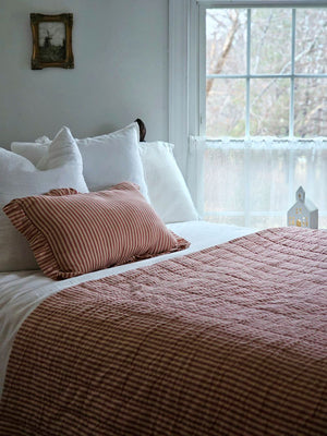 Whether you're creating a farmhouse style bedroom, a cozy cabin nook or a cottage guest room, our Red Ticking Stripe Quilt offers vintage charm. This hand-quilted, 100% cotton coverlet gets softer with each washing. Features popular ticking stripes in red along with a buttery oat stripe on one side and a solid buttery oat on the reverse side.