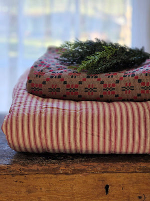 Whether you're creating a farmhouse style bedroom, a cozy cabin nook or a cottage guest room, our Red Ticking Stripe Quilt offers vintage charm. This hand-quilted, 100% cotton coverlet gets softer with each washing. Features popular ticking stripes in red along with a buttery oat stripe on one side and a solid buttery oat on the reverse side.