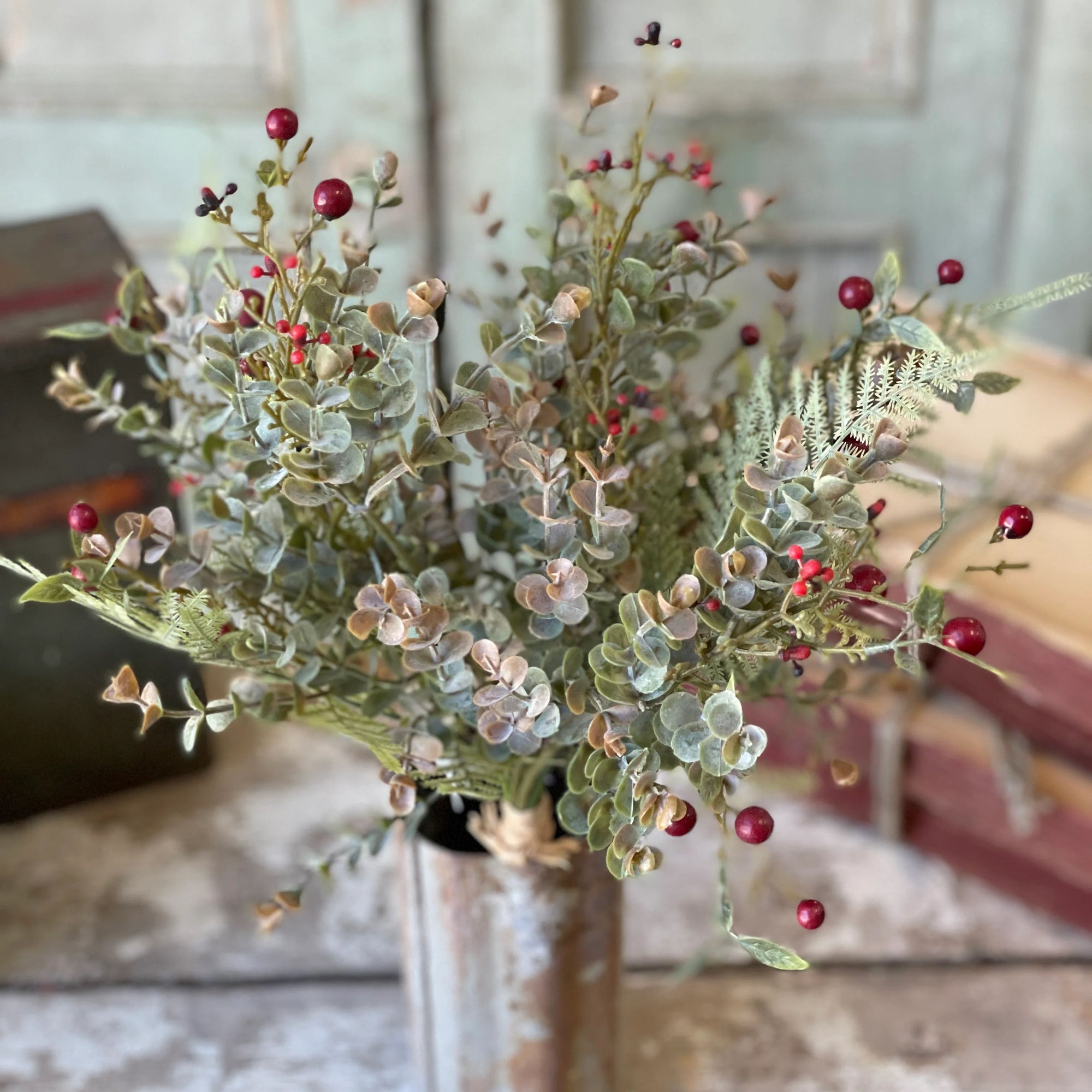 Add an elegant, earthy touch to any bowl, basket or pot with our Red Berries and Eucalyptus Bush. The soft, muted grey/green tones of this Eucalyptus combined with Red Berries lends festive charm to any room in your farmhouse. This faux bush tucks easily in any bowl or basket to create a farm table centerpiece that will look beautiful in any season. Vase not included.