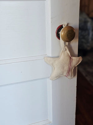 Our Red Stripe Grain Sack Star Ornament looks so charming whether you're Christmas style is French Country, Vintage Farmhouse, or classic Nordic style. This fabric star ornament offers an old-fashioned look, inspired by French grain sacks. 100% Cotton. 5.25" Diam