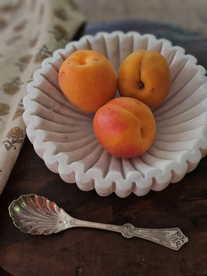 Elevate your table setting with the Ribbed Marble Bowl, featuring a refined ribbed texture and delicate light grey veining. This elegant piece combines natural beauty with subtle sophistication, making it perfect for creating unique displays. Its timeless design adds a touch of understated luxury to any space.