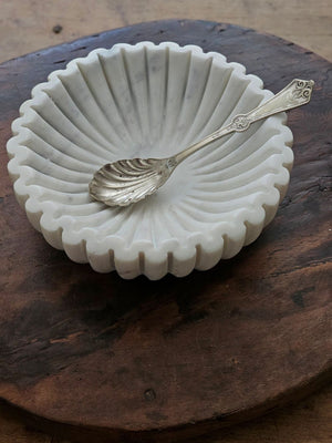 Elevate your table setting with the Ribbed Marble Bowl, featuring a refined ribbed texture and delicate light grey veining. This elegant piece combines natural beauty with subtle sophistication, making it perfect for creating unique displays. Its timeless design adds a touch of understated luxury to any space.