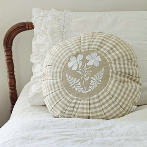 This Round Pleated Cottage Tan Gingham Pillow will bring a touch of English cottage style to any room. Featuring a classic country gingham pattern with sweet pleats and an embroidered white flower in the center, it adds instant charm and sophistication. Spot clean only. 100% cotton with Polyester insert. 16" Diam