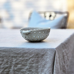 The Rustic Ceramic Colander Bowl offers relaxed farmhouse style. It's perfect for washing berries and fruit or use it to hold sponges and soap.  This oatmeal finish has a rustic appearance.  6.25"Diam x 2.75"H