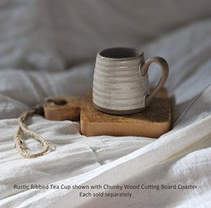 The Chunky Wood Cutting Board Coaster adds a decorative touch to any table . The rustic style board is perfect as a countertop display or hanging from hooks. For decorative use only. 7.5"L x 5.5"W x 1"H (Wood Coaster only, accents sold separately)