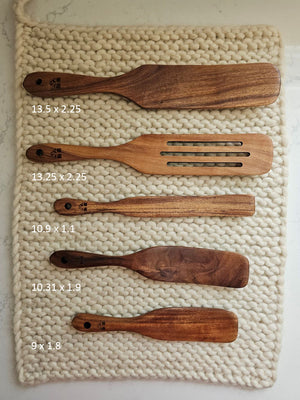 Our Rustic Wood Spurtle Spatula Set includes five durable teak wood utensils, designed for stirring, mixing, scraping, and serving. With their unique shape, these spurtles glide smoothly along cookware, making them ideal for everything from folding batter to sautéing. Lightweight yet sturdy, they offer a comfortable grip and are gentle on non-stick surfaces. A natural, eco-friendly alternative to plastic, this set brings both practicality and timeless style to any kitchen. Set of five.