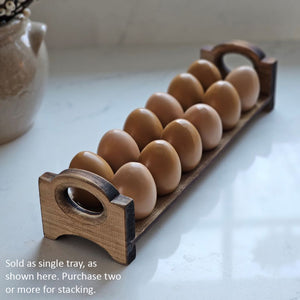 Inspired by antique egg holders, such as ones spotted in the Downton Abbey kitchen, our farmhouse Rustic Wood Stackable Egg Tray will be right at home in your kitchen. It is sold as one tray, and a purchase of two gives you that old-timey stackable look. Makes a great accent for any shelf or countertop. Each rustic wood egg crate holds 12 eggs. Eggs not included. Includes one tray. Purchase two or more for stacking. Made in the USA.