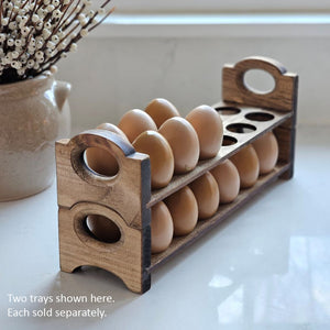 Inspired by antique egg holders, such as ones spotted in the Downton Abbey kitchen, our farmhouse Rustic Wood Stackable Egg Tray will be right at home in your kitchen. It is sold as one tray, and a purchase of two gives you that old-timey stackable look. Makes a great accent for any shelf or countertop. Each rustic wood egg crate holds 12 eggs. Eggs not included. Includes one tray. Purchase two or more for stacking. Made in the USA.