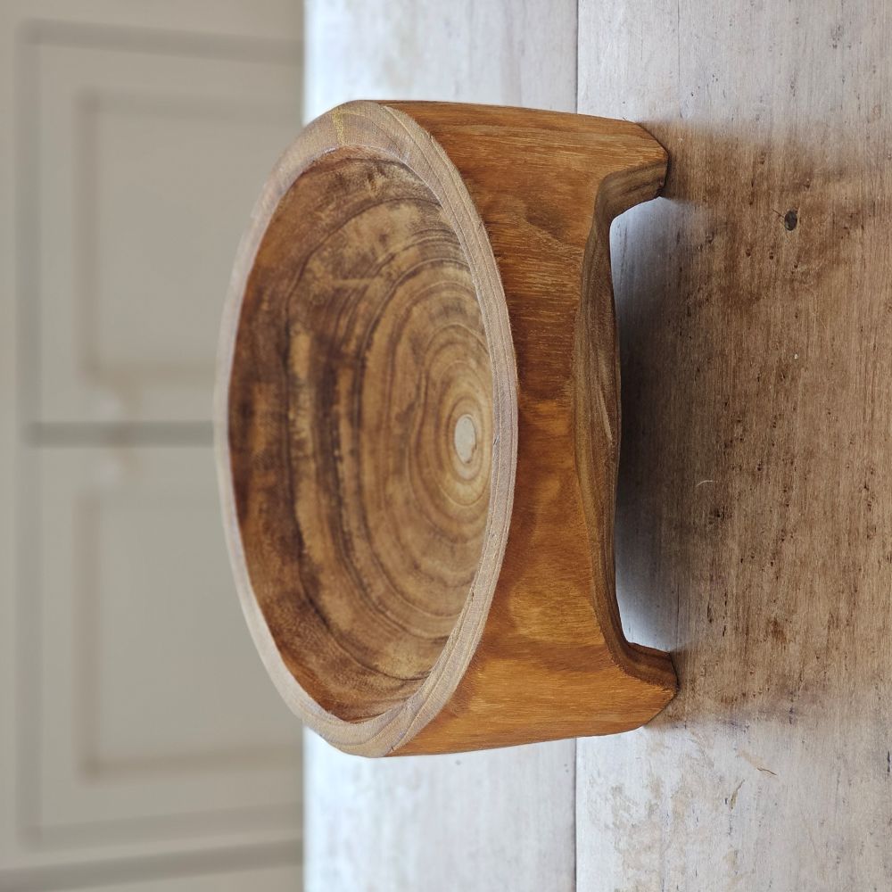 Add down-to-earth character to your farm table with our rustic Carved Wood Bowl with Legs. Inspired by the style of traditional hand-hewn dough bowls, this unique piece adds a touch of imperfection and charm. The decorative bowl is crafted from thick, carved wood and can be displayed year-round on a table, shelf, or counter. Each bowl is truly one-of-a-kind and complements any relaxed, rustic decor. Simply wipe clean with a dry cloth. Measures approximately 11.5” Diam x 4.75”H and varies in wood tone