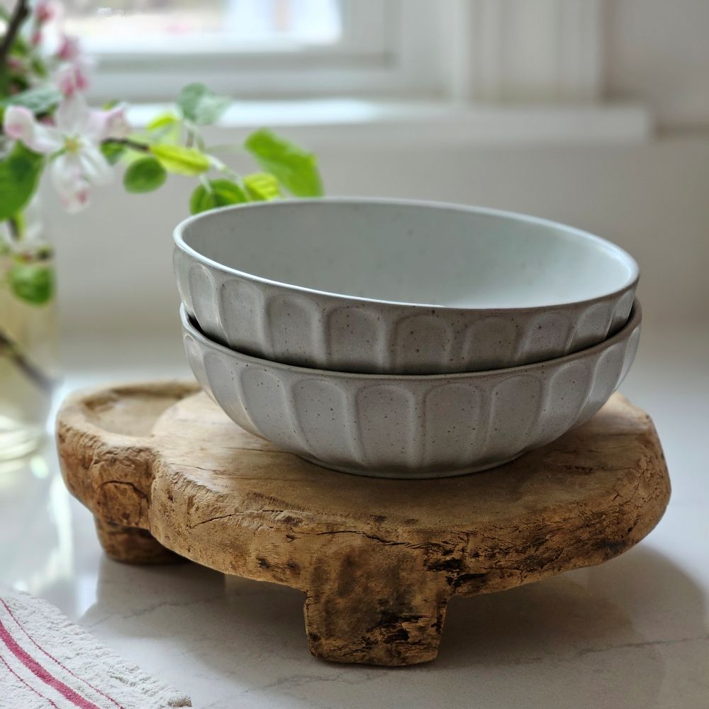 The Rustic Ceramic Pasta Bowls, Set of Two, is the perfect size for serving up pasta dishes and more. This wide bowl has a low profile and features a cool gray-white speckled glaze and ribbed design. It brings an earthy elegance to your farmhouse kitchen. Set of Two.
