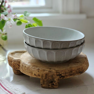 The Rustic Ceramic Pasta Bowls, Set of Two, is the perfect size for serving up pasta dishes and more. This wide bowl has a low profile and features a cool gray-white speckled glaze and ribbed design. It brings an earthy elegance to your farmhouse kitchen. Set of Two.