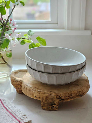 The Rustic Ceramic Pasta Bowls, Set of Two, is the perfect size for serving up pasta dishes and more. This wide bowl has a low profile and features a cool gray-white speckled glaze and ribbed design. It brings an earthy elegance to your farmhouse kitchen. Set of Two.