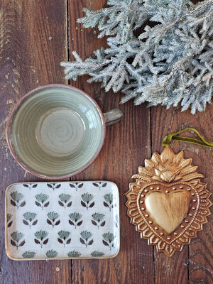 Embrace warmth and comfort with the Rustic Ceramic Soup Mug. Handcrafted with care, this earthy ceramic mug is designed to warm your hands while holding your favorite soups, stews, oatmeal, or hot beverages. Finished with a reactive glaze, each piece features unique variations in color and speckling, adding an organic and artisanal touch to your tableware collection.