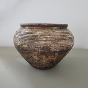 Add down-to-earth elegance to any room with our Rustic Distressed Clay Pot Vase. The washed brow finish lends a textured look, giving this piece an old-world, organic touch. The watertight finish allows you to display your favorite fresh floral arrangements to create stunning farm table centerpieces. 9" diam x 6.5"H