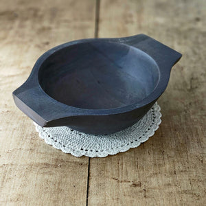 Expertly crafted from mango wood and finished with a dark rustic look, our Rustic Peasant Bowl adds a touch of primitive charm to any setting. With its mini dough bowl design, it's perfect for displaying small treasures on any table or shelf. 