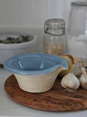 The Rustic Pour Bowl with Blue Glaze lends a vintage, old-world farmhouse look to any kitchen. It features a rustic hand-thrown pottery look with pour spout. The cottage blue glaze and unglazed bottom add to its rustic feel. 