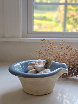 The Rustic Pour Bowl with Blue Glaze lends a vintage, old-world farmhouse look to any kitchen. It features a rustic hand-thrown pottery look with pour spout. The cottage blue glaze and unglazed bottom add to its rustic feel. 